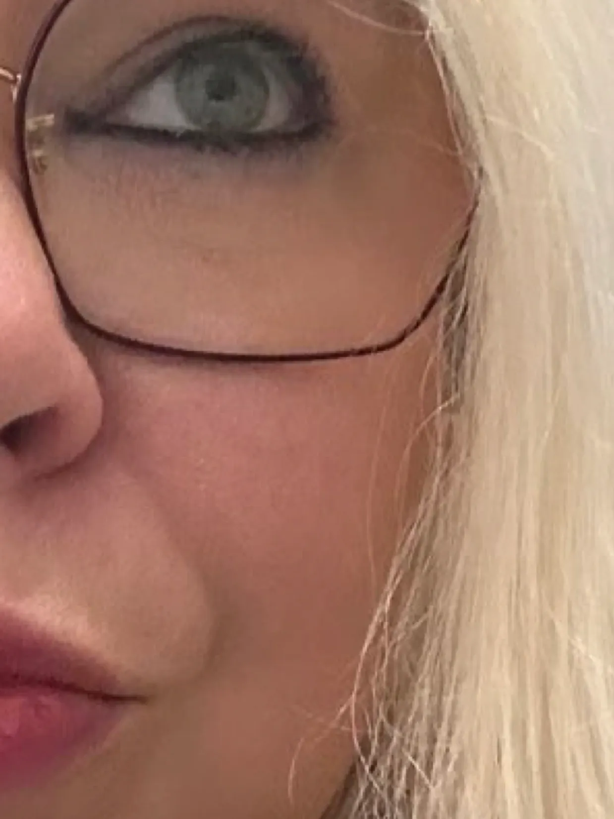 A close up of the face of a woman with blonde hair.